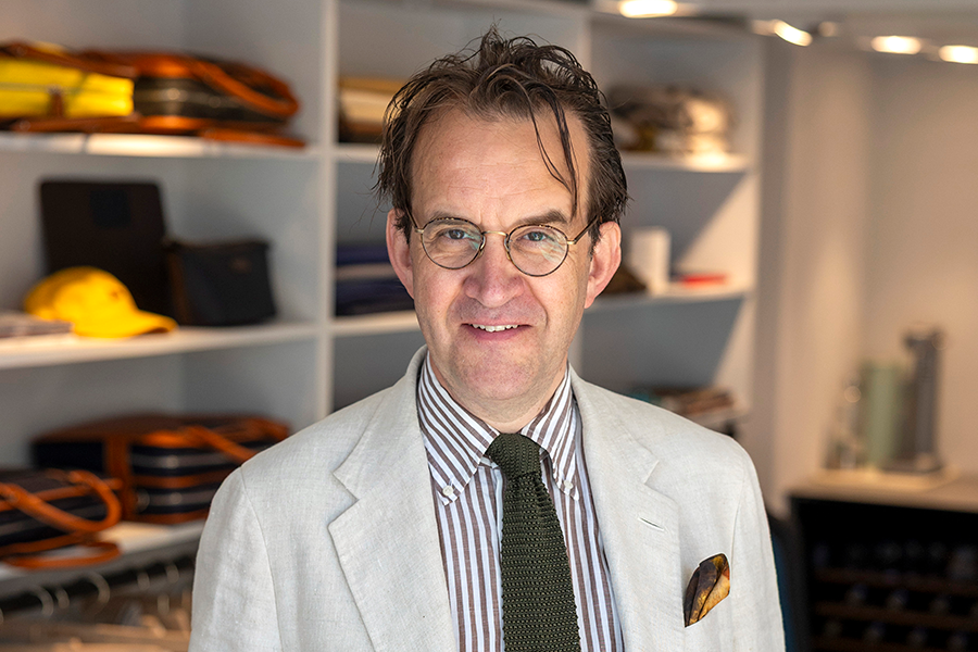 Man met bril in pak in kledingwinkel